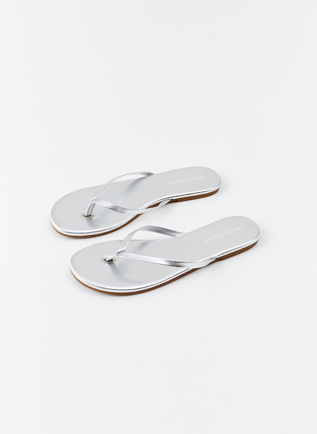 White fashion and silver flip flops